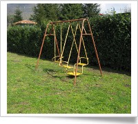 Giardino con altalena e giochi per bambini al Country House Poggio dei Signori